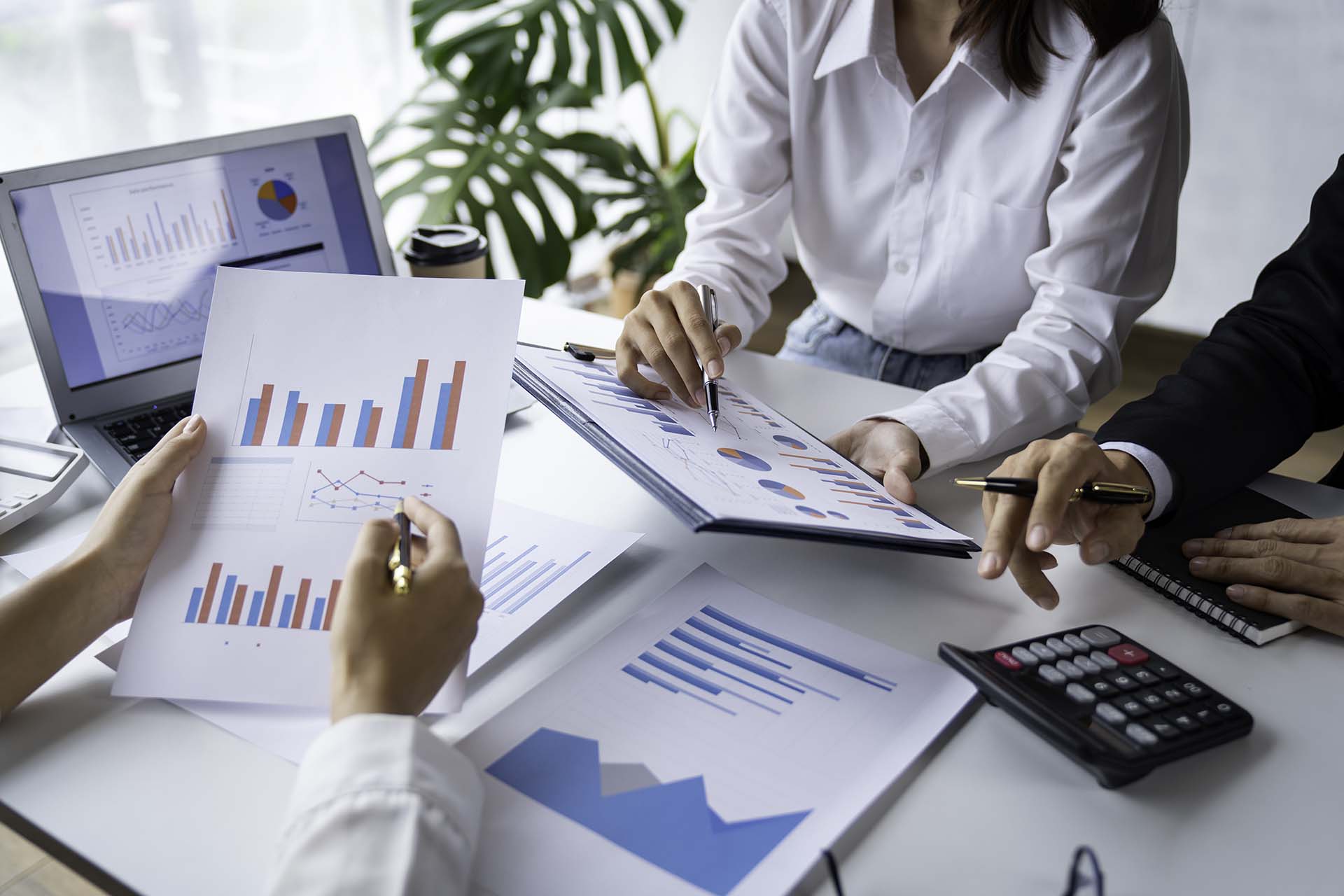 business people meeting in the office Calculate the tax and income of the company's investment.